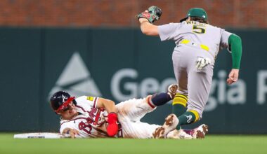 Mar 30, 2026; Cumberland, Georgia, USA; Athletics shortstop Jacob Wilson (5) makes a tag for an out against Atlanta Braves catcher Drake Baldwin (30) during the ninth inning at Truist Park. Mandatory Credit: Jordan Godfree-Imagn Images