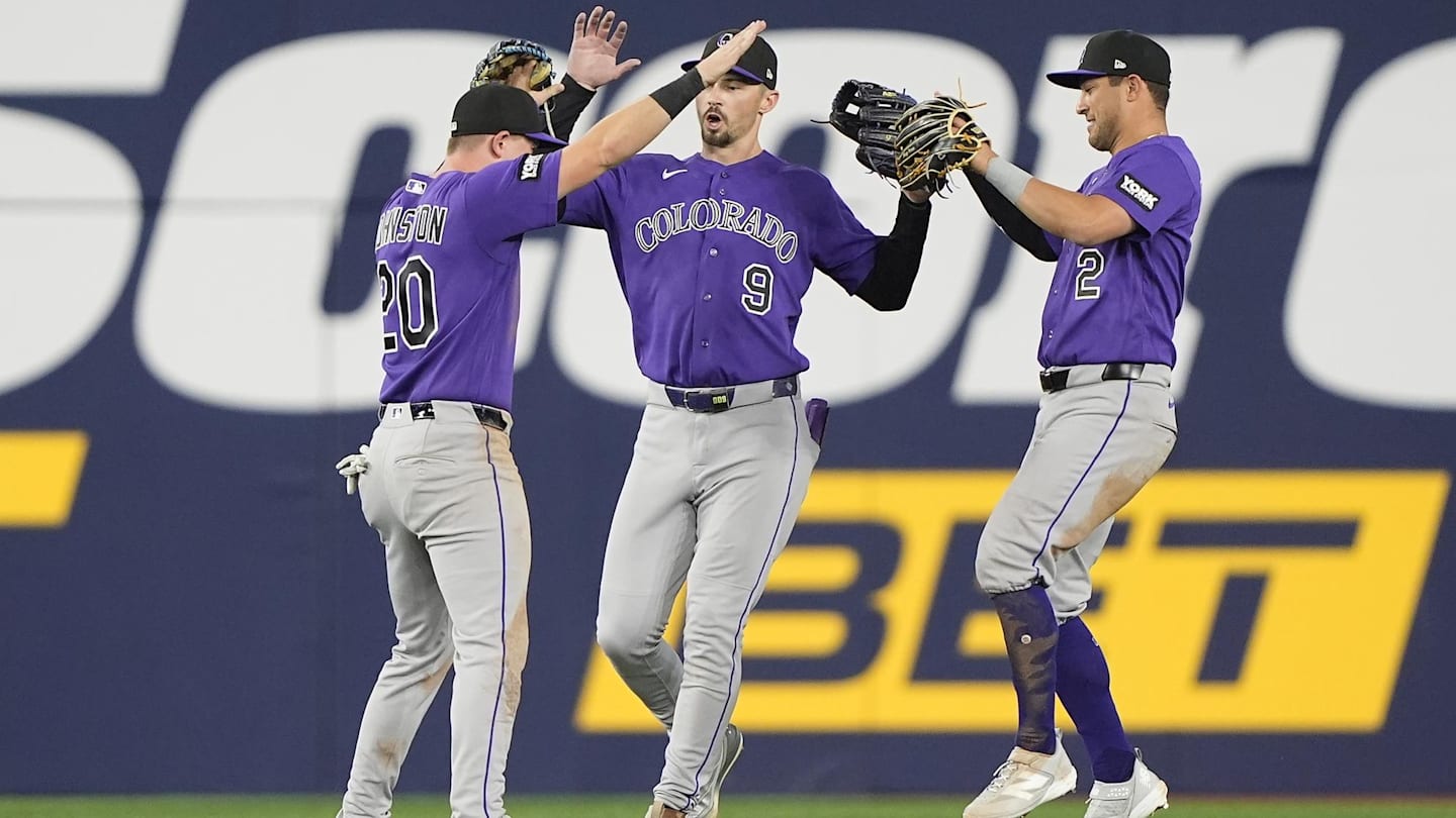Apr 1, 2026: Colorado Rockies left fielder Troy Johnston (20) and center fielder Brenton Doyle (9)  and right fielder Tyler Freeman (2) celebrate a win over the Toronto Blue Jays after the tenth inning at Rogers Centre.