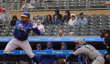 Apr 24, 2025; Minneapolis, Minnesota, USA; Fans sit in the rain and watch as the Chicago White Sox play the Minnesota Twins in the second inning at Target Field. Mandatory Credit: Bruce Kluckhohn-Imagn Images