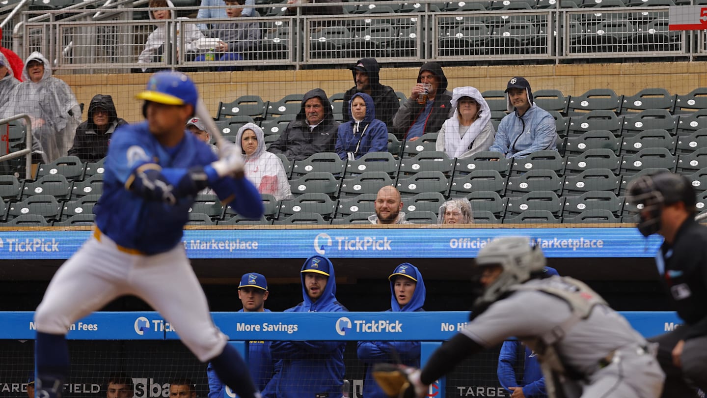Apr 24, 2025; Minneapolis, Minnesota, USA; Fans sit in the rain and watch as the Chicago White Sox play the Minnesota Twins in the second inning at Target Field. Mandatory Credit: Bruce Kluckhohn-Imagn Images