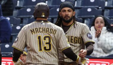 San Diego Padres right fielder Fernando Tatis Jr. greets third baseman Manny Machado.
