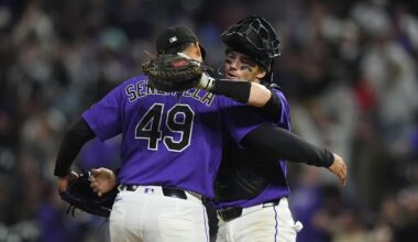 Apr 7, 2026; Denver, Colorado, USA; Colorado Rockies relief pitcher Antonio Senzatela (49) and catcher Brett Sullivan (26) celebrate defeating the Houston Astros in the inning at Coors Field. Mandatory Credit: Ron Chenoy-Imagn Images
