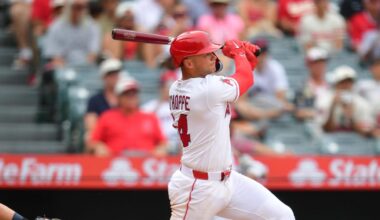 Apr 5, 2026; Anaheim, California, USA; Los Angeles Angels catcher Logan O'Hoppe (14) hits a sacrifice RBI against the Seattle Mariners during the tenth inning at Angel Stadium. Mandatory Credit: Gary A. Vasquez-Imagn Images