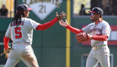 Apr 16, 2026; Pittsburgh, Pennsylvania, USA;  Washington Nationals shortstop CJ Abrams (5) and second baseman  Nasim Nuñez (right) celebrate after defeating the Pittsburgh Pirates I ten innings at PNC Park. Mandatory Credit: Charles LeClaire-Imagn Images