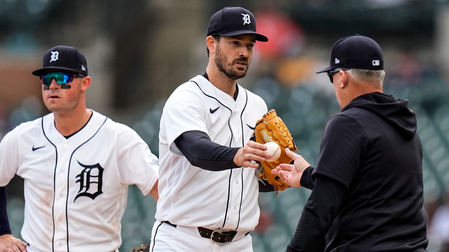 Detroit Tigers pitcher Drew Anderson (38) hands the ball to manager A.J. Hinch (14) for pitching change against Kansas City Royals during the seventh inning at Comerica Park in Detroit on Thursday, April 16, 2026.