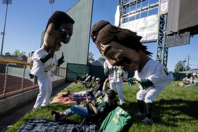 Audrey Williamson of West Sacramento is greeted by Rickey Henderson, Rollie Fingers and Dennis Eckersley before the start of the Athletics and Houston Astros game on Friday, April 3, 2026, at Sutter Health Park in West Sacramento.