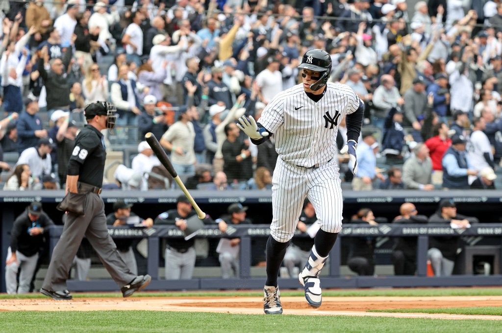 Yankees right fielder Aaron Judge (99) tosses his bat after he hits a solo home run during the first inning.