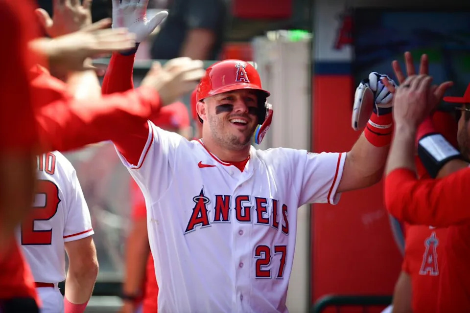 Apr 5, 2026; Anaheim, California, USA; Los Angeles Angels center fielder Mike Trout (27) is greeted after scoring a run against the Seattle Mariners during the third inning at Angel Stadium. Mandatory Credit: Gary A. Vasquez-Imagn Images