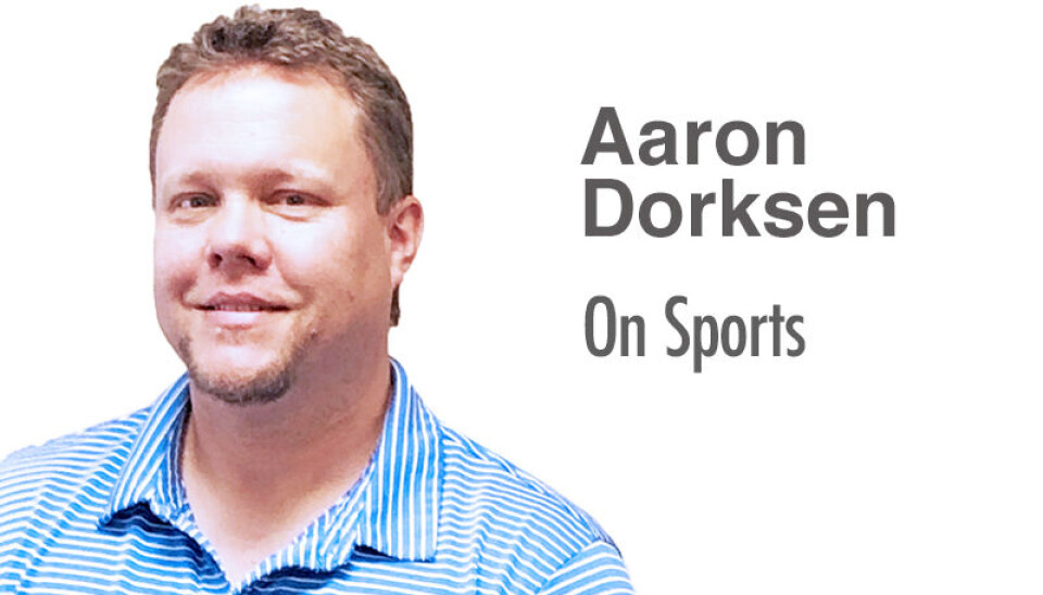 Aaron Dorksen in a striped shirt discussing sports.