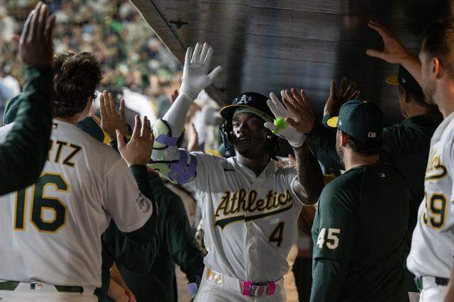 Athletics right fielder Lawrence Butler (4) is greeted by teammates after hitting a home run in the bottom of the fourth inning against the Houston Astros on Friday, April 3, 2026, at Sutter Health Park in West Sacramento.