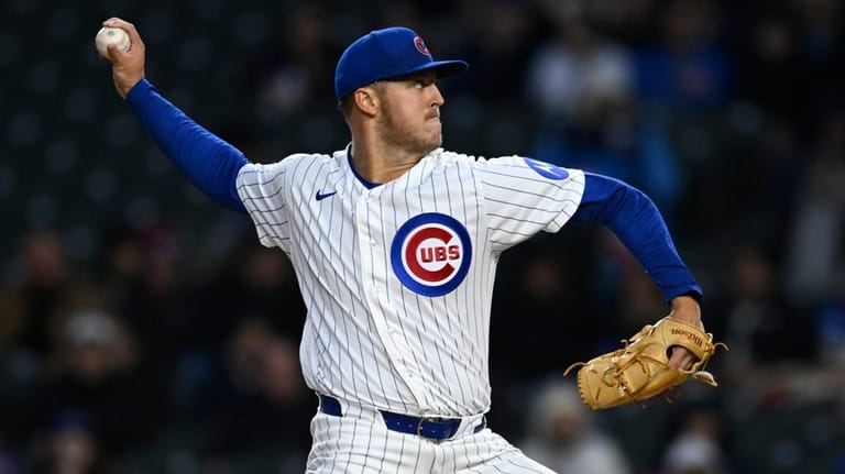 Chicago Cubs starter Jameson Taillon delivers a pitch during the...