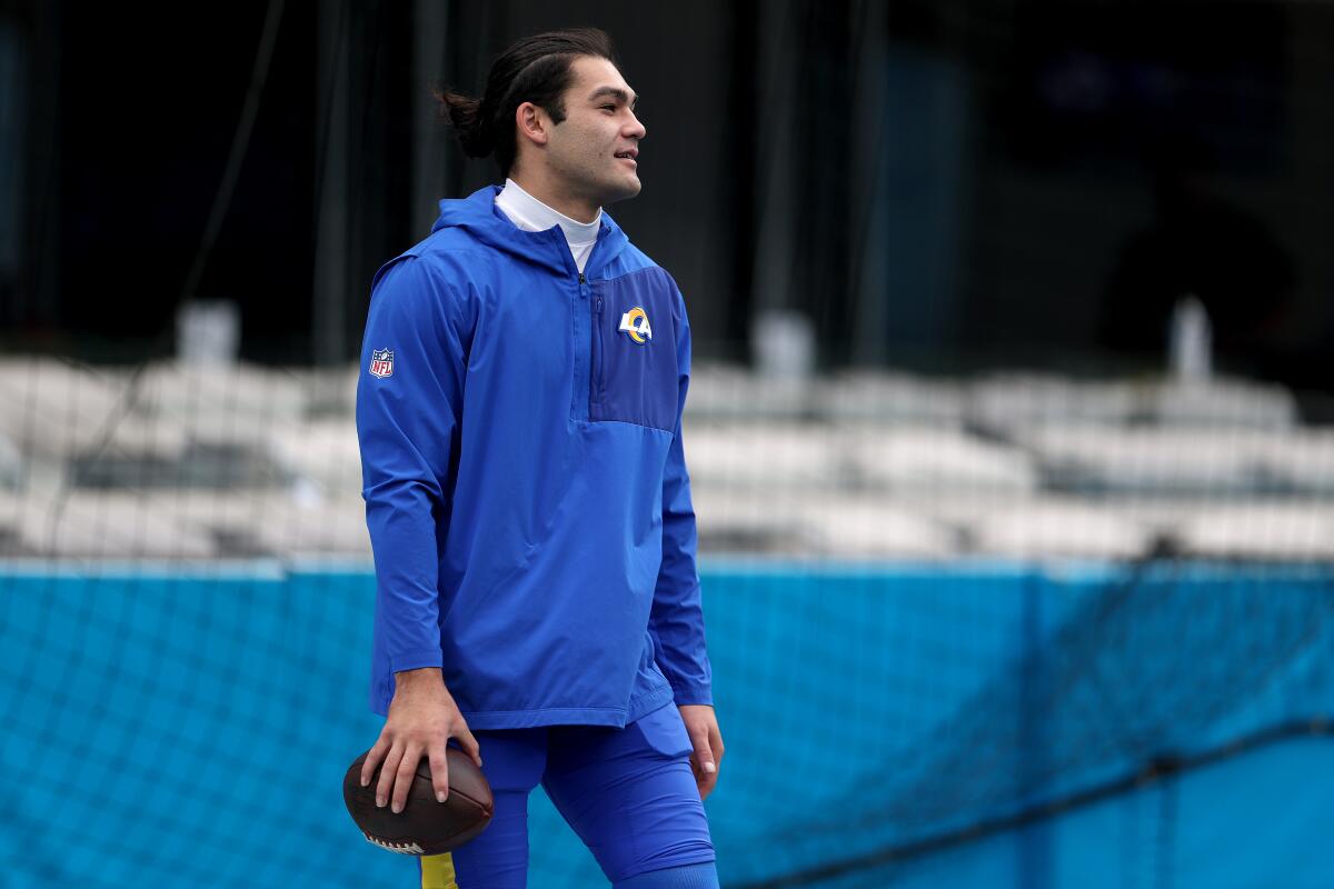 Rams wide receiver Puka Nacua stands on the field before a playoff game against the Carolina Panthers in January.