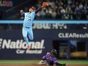 Colorado Rockies’ Jake McCarthy steals second base as Toronto Blue Jays second baseman Andrés Giménez tries to make the tag during Wednesday’s game. 
