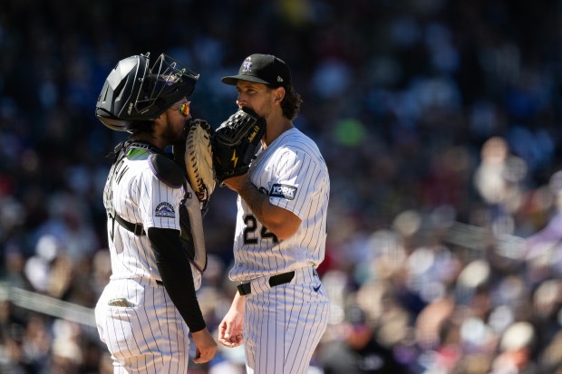 Catcher Hunter Goodman (15) of the Colorado Rockies goes to the mound to talk with pitcher Michael Lorenzen (24) of the Colorado Rockies after giving up seven runs in the first inning during the Rockies' season home opener against the Philadelphia Phillies on Friday, April 3, 2026, at Coors Field in Denver. (Photo by Timothy Hurst/The Denver Post)
