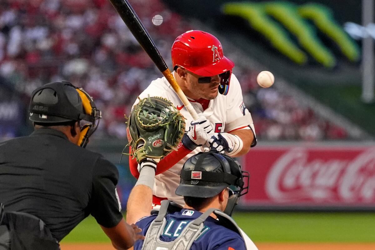 Angels star Mike Trout is hit by a pitch during the first inning Friday against the Mariners.