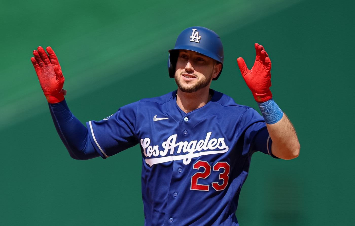 The Dodgers’ Kyle Tucker gestures to his dugout as he...