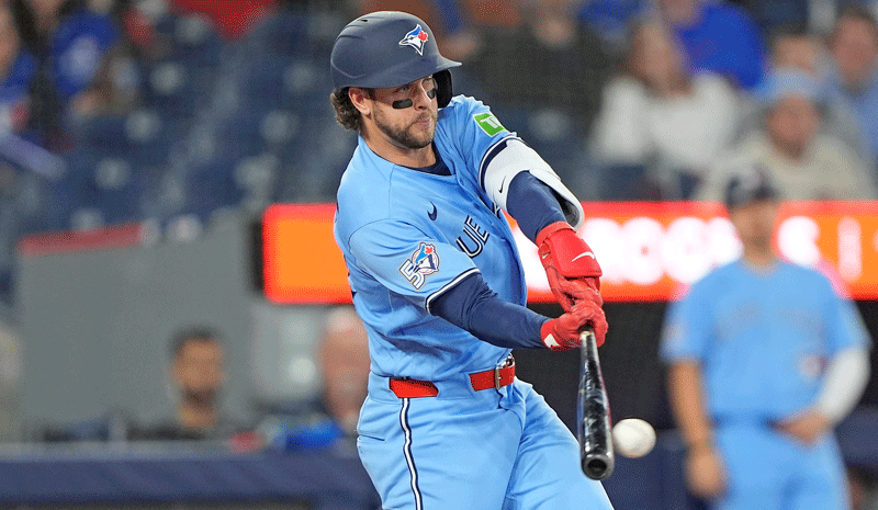 Ernie Clement (22) hits a single against the Colorado Rockies.