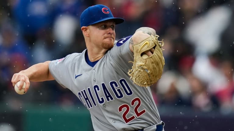 Chicag Cubs' Cade Horton pitches in the rain in the...