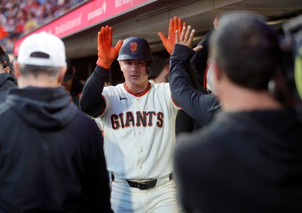San Francisco Giants' Matt Chapman #26 is congratulated by teammates after scoring on a single by Heliot Ramos #17 in the third inning of their MLB game against the Philadelphia Phillies at Oracle Park in San Francisco, Calif., on Monday, April 6, 2026. (Jane Tyska/Bay Area News Group)