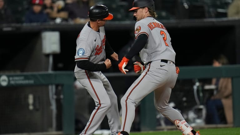 Baltimore Orioles' Gunnar Henderson (2), right, celebrates with third base...
