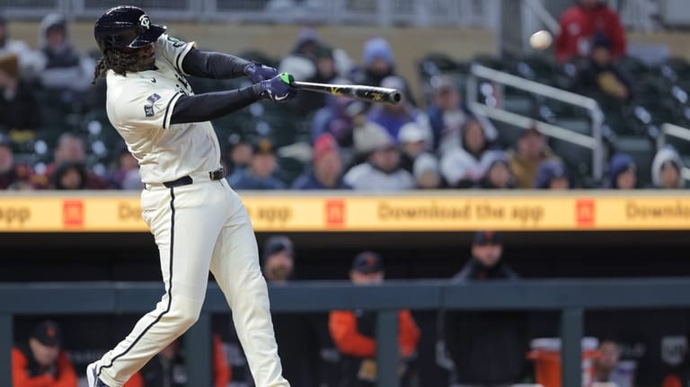 Minnesota Twins designated hitter Josh Bell hits an RBI-double during...
