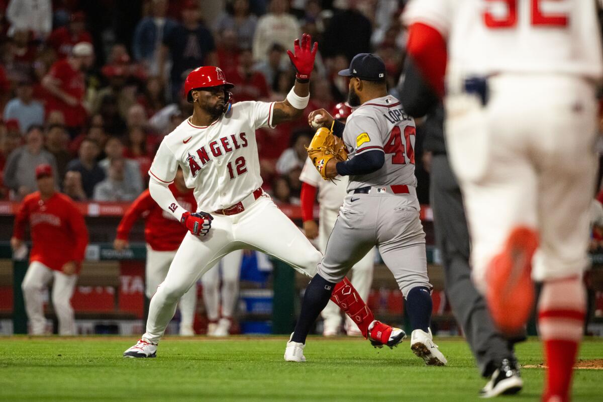 Angels batter Jorge Soler, left, fights Atlanta Braves pitcher Reynaldo López as the benches clear.
