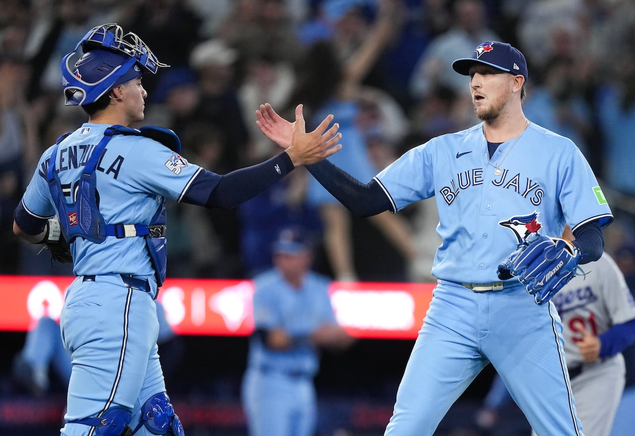 Blue Jays catcher Brandon Valenzuela and pitcher Jeff Hoffman celebrate a Toronto victory over the L.A. Dodgers