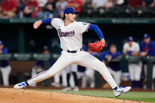 Texas Rangers pitcher Cole Winn throws to the Seattle Mariners in the ninth inning of a baseball game Wednesday, April 8, 2026, in Arlington, Texas. (AP Photo/Tony Gutierrez)