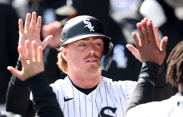White Sox second baseman Chase Meidroth is congratulated by teammates in the dugout after scoring on Lenyn Sosa's third-inning single against the Orioles on Tuesday, April 7, 2026, at Rate Field. (Chris Sweda/Chicago Tribune)