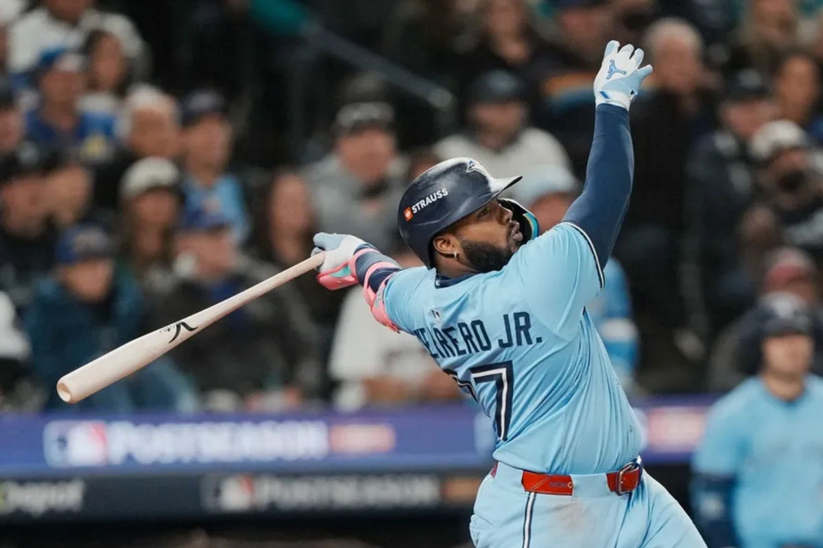 Oct 16, 2025; Seattle, Washington, USA; Toronto Blue Jays first baseman Vladimir Guerrero Jr. (27) hits a solo home run against the Seattle Mariners in the seventh inning during game four of the ALCS round for the 2025 MLB playoffs at T-Mobile Park. Mandatory Credit: Stephen Brashear-Imagn Images