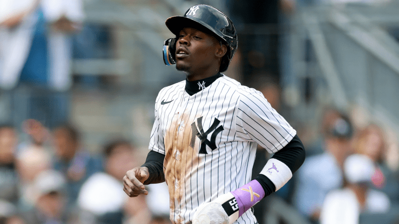 Jazz Chisholm Jr. #13 of the New York Yankees scores after Aaron Judge is hit by a pitch with the bases loaded in the second inning against the Miami Marlins during the home opener at Yankee Stadium on April 03, 2026 in the Bronx borough of New York City. (Photo by Elsa/Getty Images)