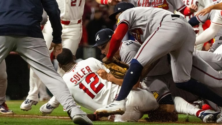 Los Angeles Angels' Jorge Soler (12) is tackled to the...