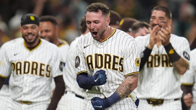 San Diego Padres' Jackson Merrill, center, celebrates with teammates after...