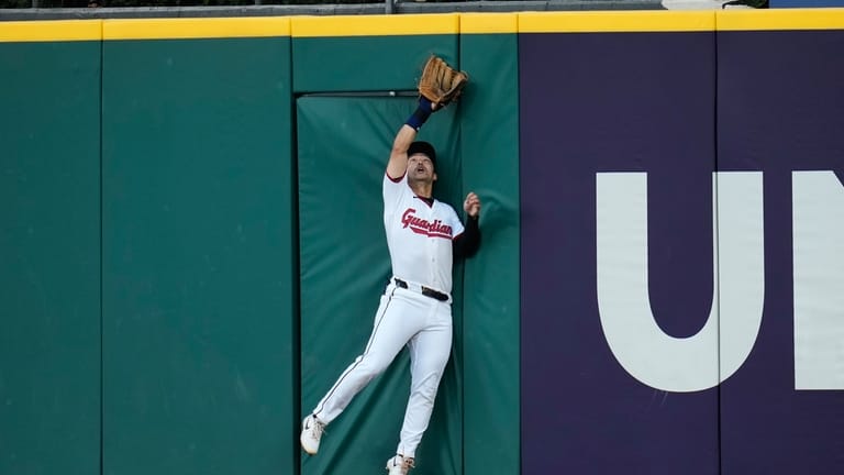 Cleveland Guardians center fielder Steven Kwan catches a fly ball...