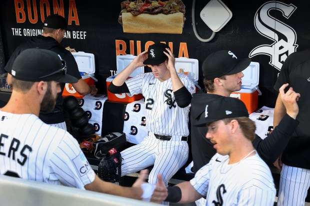 Chicago White Sox starting pitcher Noah Schultz (center) sits in the dugout before his major league debut against the Tampa Bay Rays at Rate Field in Chicago on April 14, 2026. (Chris Sweda/Chicago Tribune)