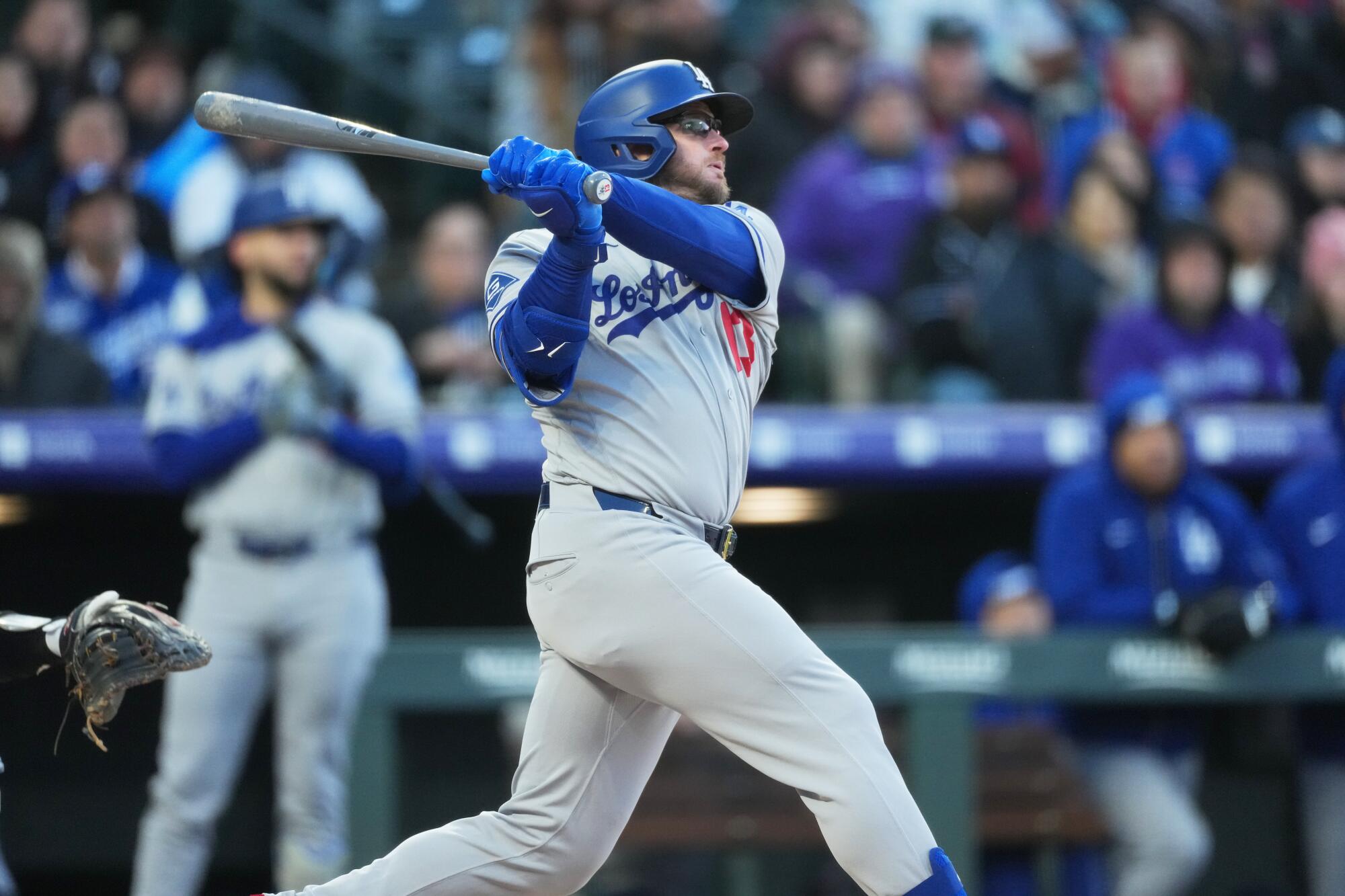 Dodger Max Muncy follows the flight of his solo home run off Colorado Rockies starting pitcher Tomoyuki Sugano Friday.