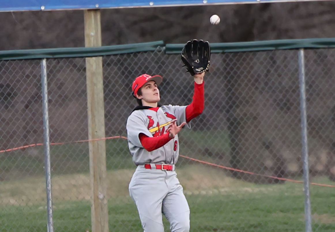 Alton's Grant Ely makes a catch in a March 17 baseball game vs. Marquette Catholic at Hopkins Field in Alton. Ely played in the Busch Stadium outfield on Friday against Father McGivney in St. Louis. 