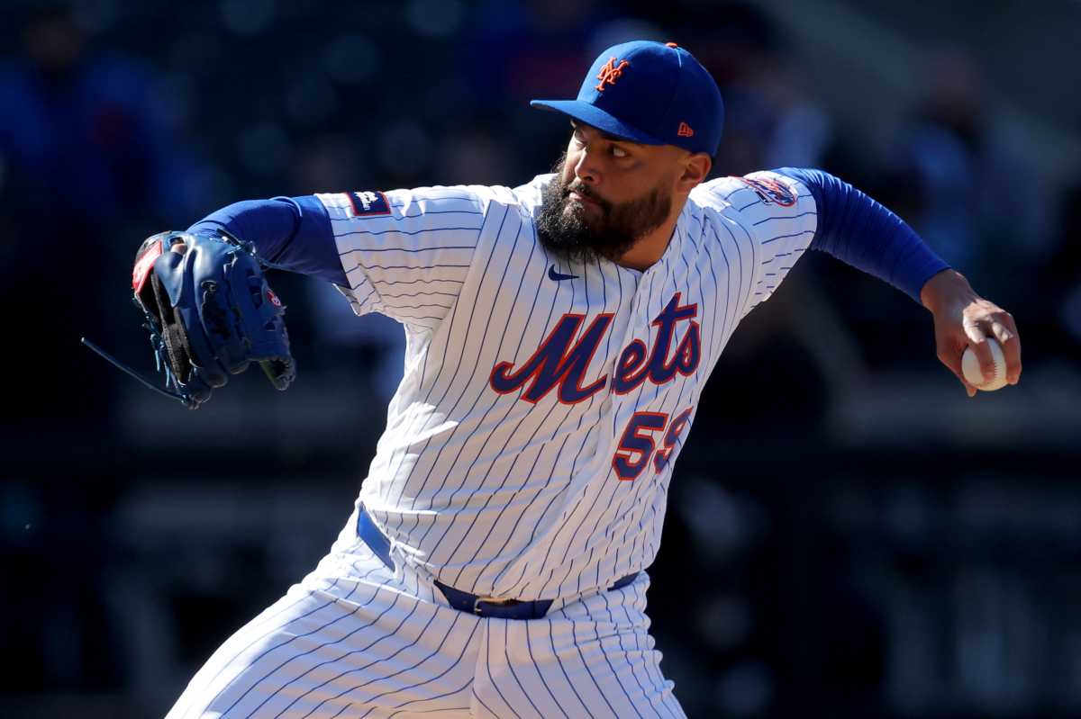 Sean Manaea Mets Pirates Opening Day: Man in white uniform and blue hat throws baseball