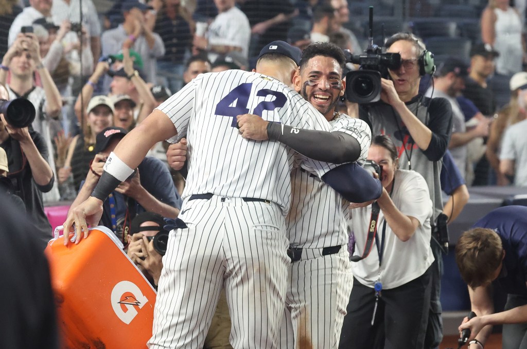 New York Yankees right fielder Aaron Judge (99) douses New York Yankees shortstop José Caballero (72) with water after he hit a two-run RBI hit