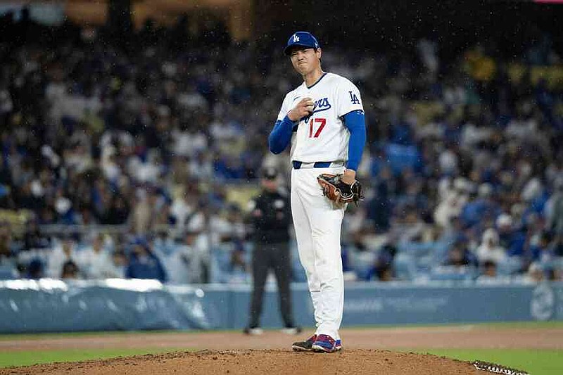 Los Angeles Dodgers starting pitcher Shohei Ohtani gestures to Cleveland Guardians' Angel Martínez after Martínez got hit by a pitch during the fifth inning of a baseball game in Los Angeles, Tuesday, March 31, 2026. (AP Photo/Kyusung Gong)