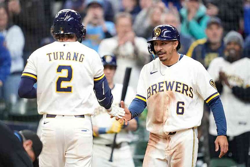 Milwaukee Brewers' David Hamilton (6) high-fives Brice Turang (2) following Turang's two-run home run during the third inning of a baseball game against the Tampa Bay Rays, Wednesday, April 1, 2026, in Milwaukee. (AP Photo/Kayla Wolf)