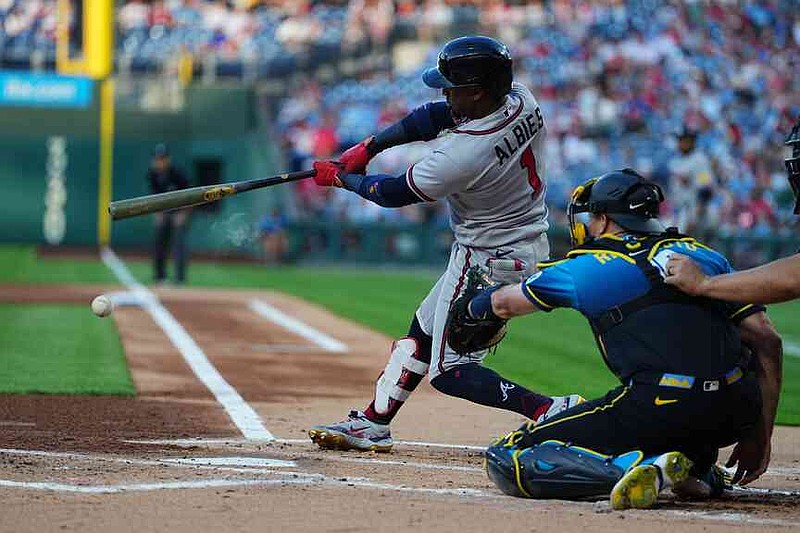 Atlanta Braves' Ozzie Albies hits a one-run single off of Philadelphia Phillies pitcher Taijuan Walker during the first inning of a baseball game, Friday, April 17, 2026, in Philadelphia. (AP Photo/Matt Rourke)