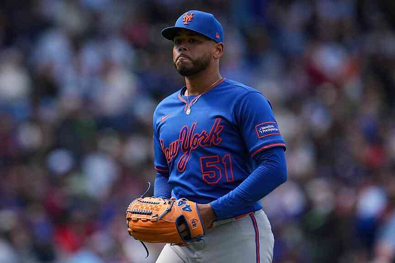 New York Mets starting pitcher Freddy Peralta (51) returns to the dugout after a pitching change during the sixth inning of a baseball game against the Chicago Cubs, Saturday, April 18, 2026, in Chicago. (AP Photo/Erin Hooley)