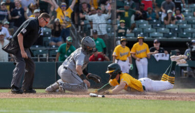 Chicago White Sox catcher Reese McGuire, center, attempts to get Athletics' Jacob Wilson o ...