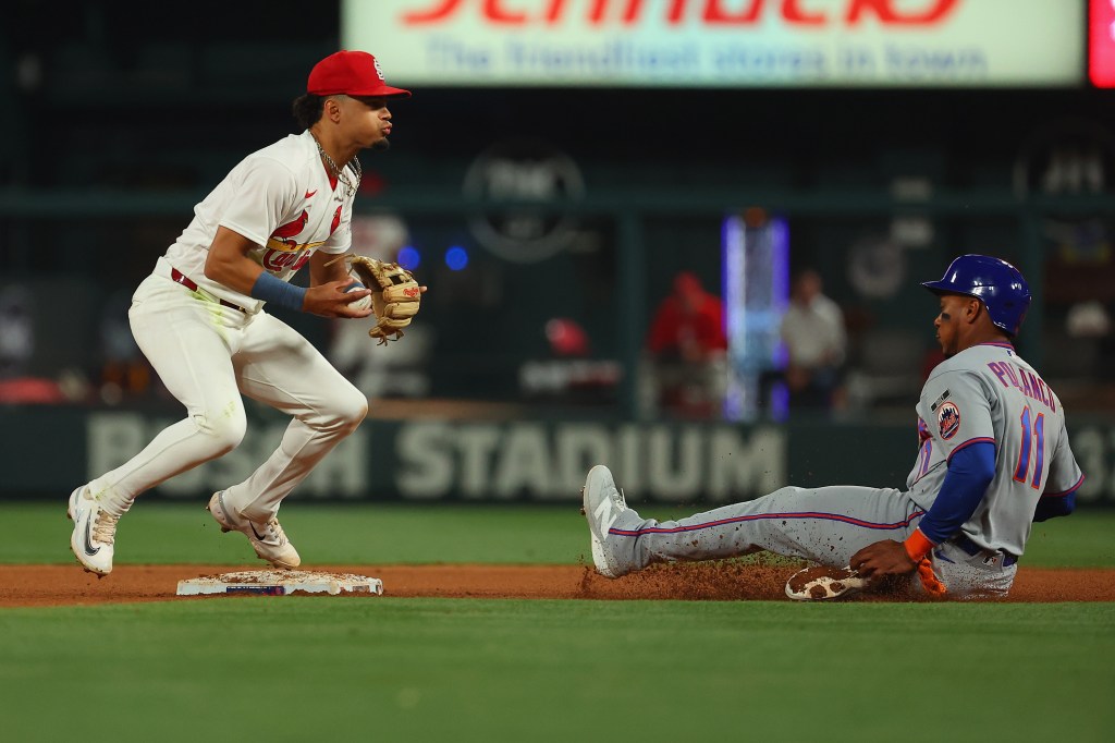 Masyn Winn #0 of the St. Louis Cardinals beats Jorge Polanco #11 of the New York Mets to second base for an out in the seventh inning at Busch Stadium on March 30, 2026 in St Louis, Missouri. 