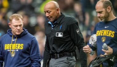 MLB umpire C.B. Bucknor leaves the game after taking foul ball to the face