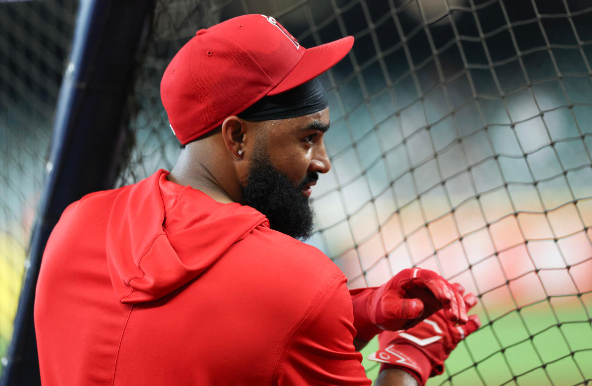 Mar 28, 2026; Houston, Texas, USA; Los Angeles Angels right fielder Jo Adell (7) talks to an assistant coach while waiting his turn to take batting practice before playing against the Houston Astros at Daikin Park. Mandatory Credit: Thomas Shea-Imagn Images