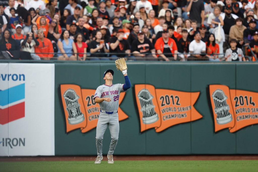 Jared Young #29 of the New York Mets catches a fly ball hit by Rafael Devers #16 of the San Francisco Giants in the bottom of the third inning at Oracle Park on April 04, 2026 in San Francisco, California. 