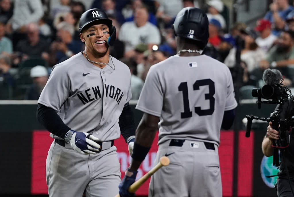 Aaron Judge is all smiles as he celebrates with Jazz Chisholm after hitting a solo homer in the ninth inning of the Yankees’ win over the Rangers. AP