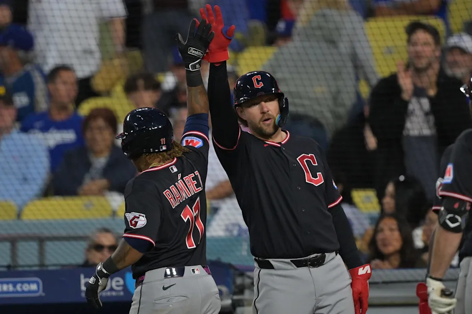 Cleveland Guardians' Jose Ramirez (11) is greeted at the dugout after hitting a two-run home run against the Los Angeles Dodgers on April 1, 2026, in Los Angeles, California.